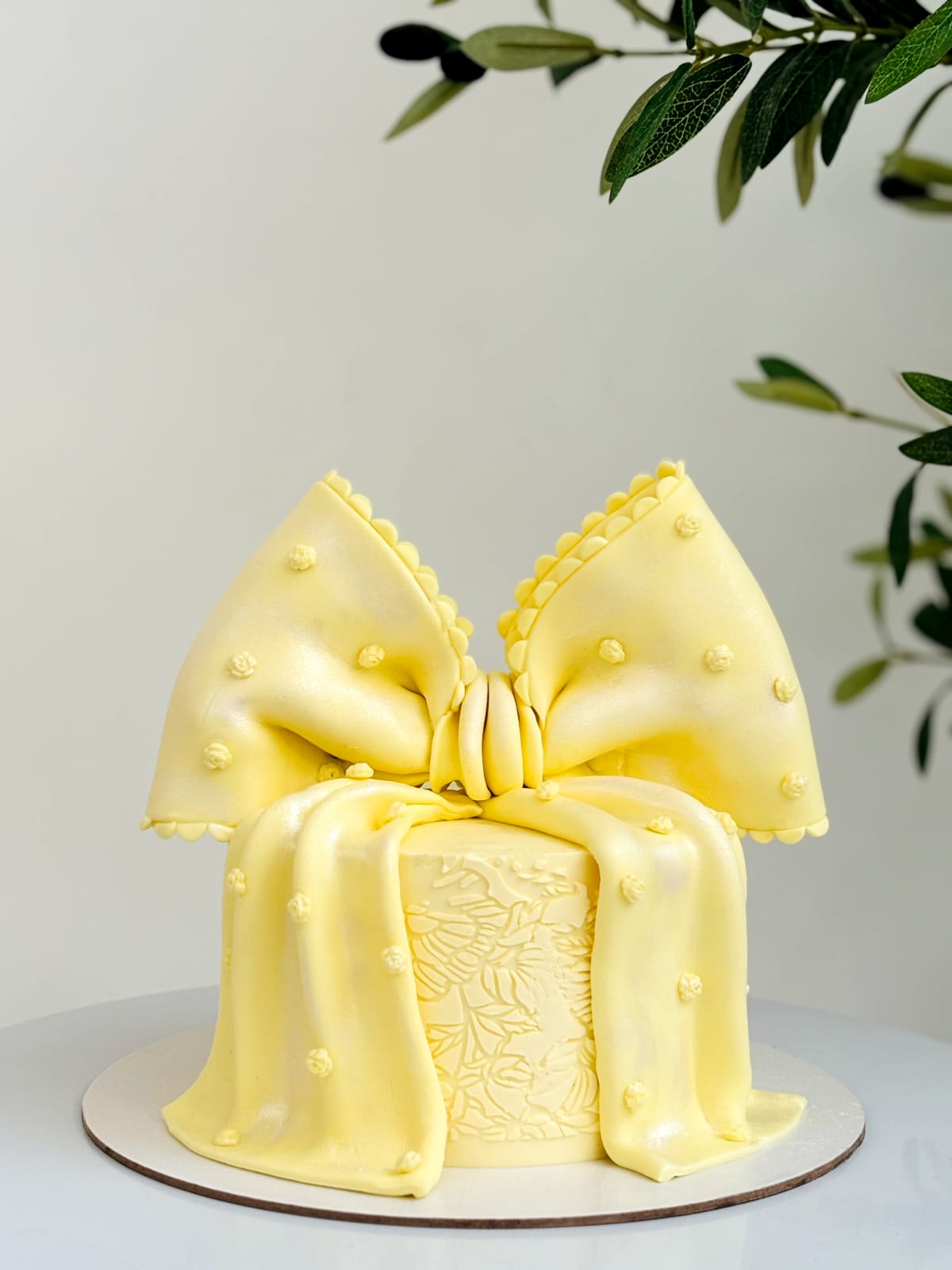 Sunshine yellow bow cake with floral embossing
